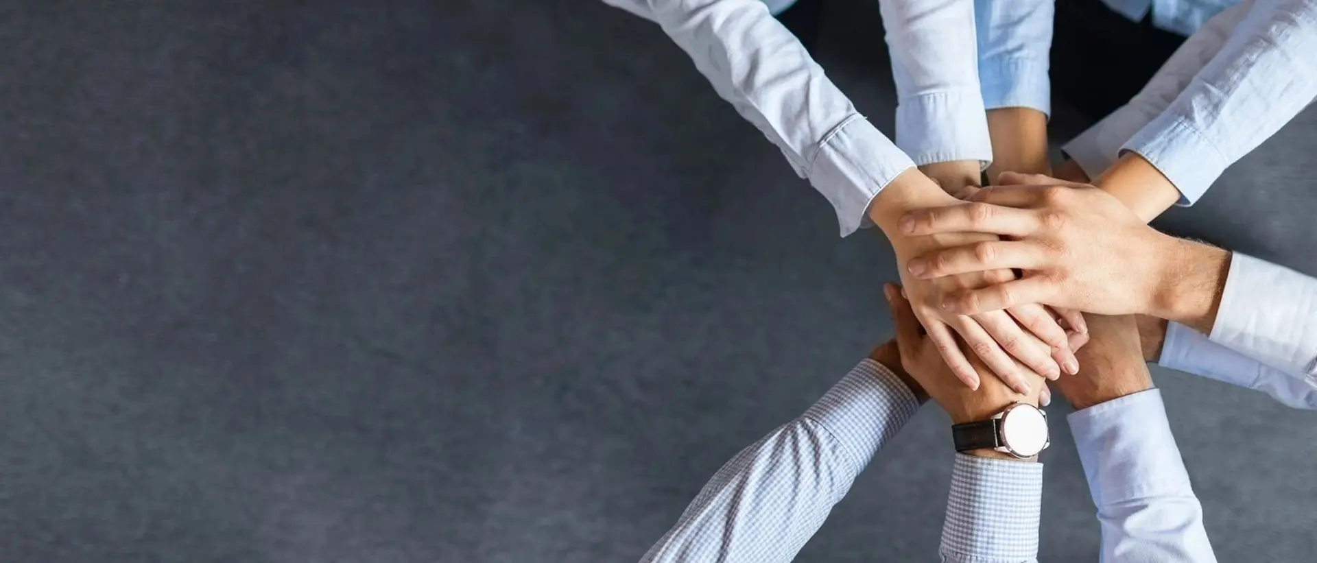 Shot of a group of coworkers with their hands stacked