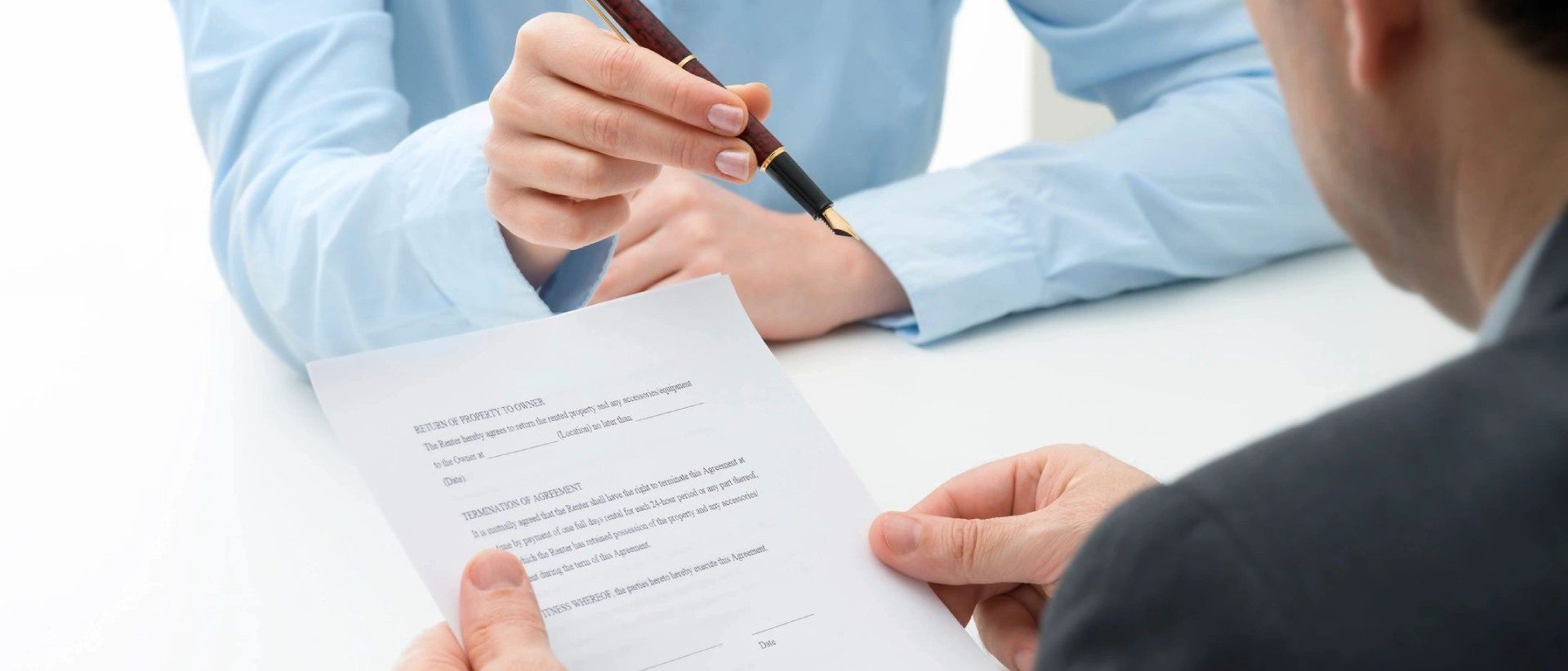 Business lady offering businessman pen for signing a contract