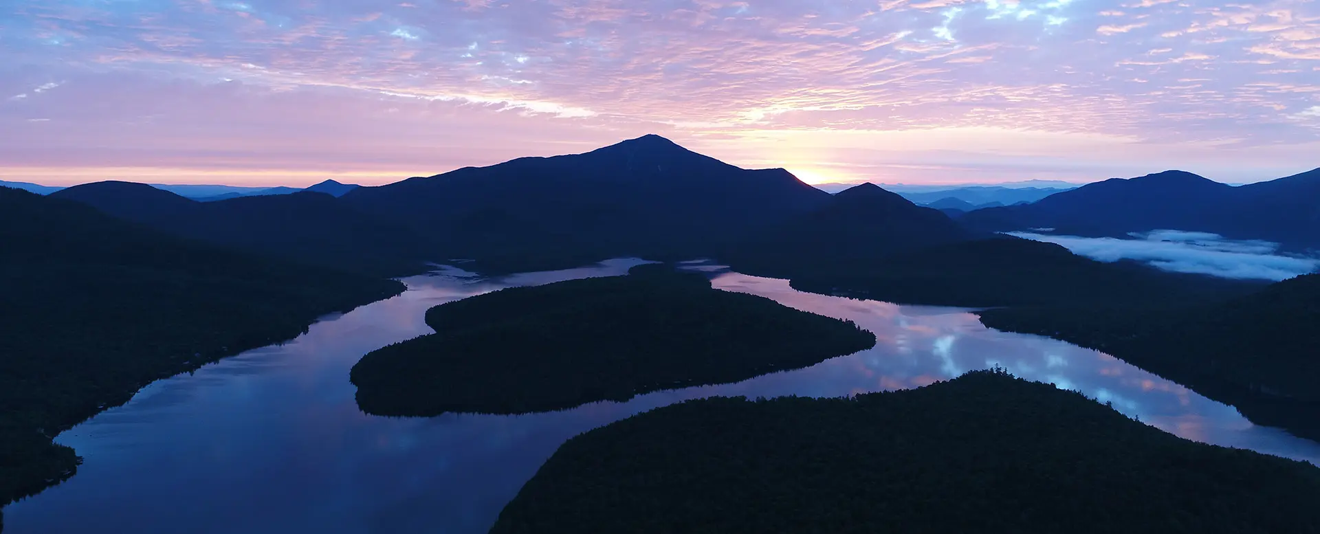 Blue lake plansee and heiterwanger see at dawn with ground fog clouds